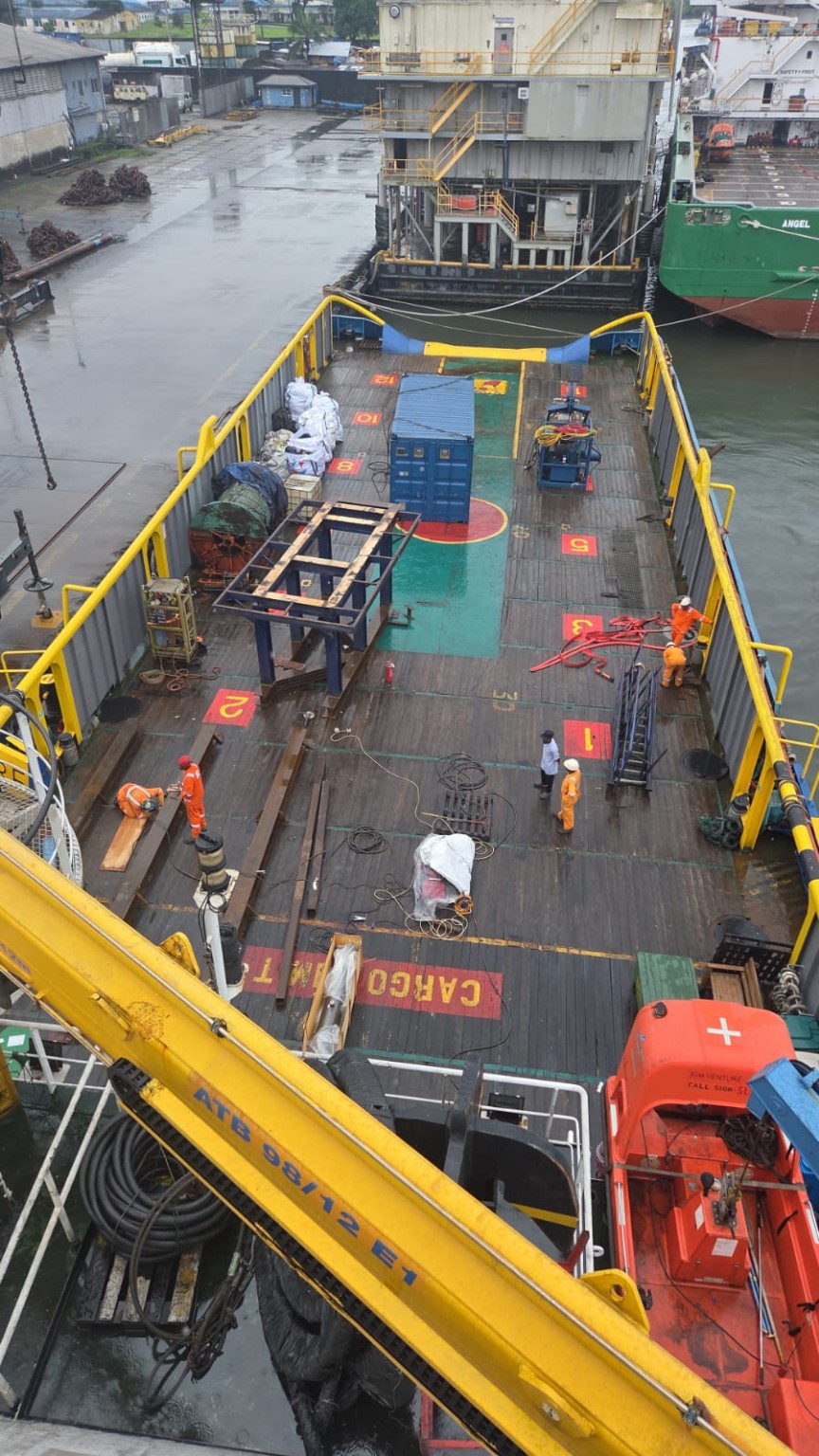 Offshore vessel deck with marine crew and operational equipment